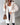 Blush pink teddy coat for women made from faux fur, showcasing a cozy and stylish winter outerwear design with long sleeves and a soft texture.