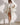 Oversized white teddy coat for women, elegantly styled, showcasing its plush texture and long sleeves, worn by a model.