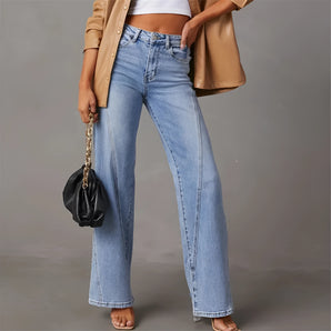 Woman wearing light blue high-waisted flared jeans in 70s style with a focus on denim fabric.