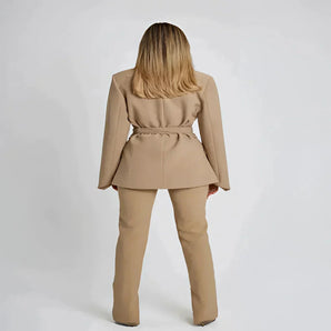 Women's beige belted blazer featuring a chic waist tie, tailored for office wear with a stylish collar and long sleeves.