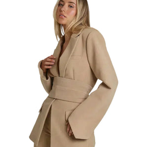 Women's beige belted blazer with chic waist tie, tailored for office wear, featuring a collar, long sleeves, and a fitted design suitable for a professional setting.