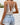 Boho Floral Spitzen-Body in Bianco, featuring a backless design, summer-style floral lace pattern, with a focus on the shoulder, neck, and waist areas, paired with jean shorts.