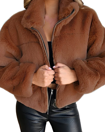 
A close-up image of a women's beige teddy jacket in a soft fleece material, featuring a zip-up design with a high collar. The jacket is shown in a brown color variant, size 5XL. The focus is on the texture and style of the outerwear, emphasizing the cozy and fashionable aspects.