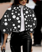 Neon green cropped jacket with black polka dots, featuring long sleeves and a stylish urban design, displayed on a mannequin against a neutral background.