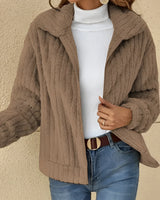 A woman wearing a cozy, brown teddy jacket with a fleece collar, paired with jeans. The jacket is suitable for autumn and winter, available in khaki color and 5XL size.