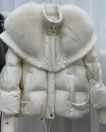 Beige designer women's winter jacket with a fur collar, featuring a grey down coat style, highlighting sleeves and fashion design elements made from natural materials.