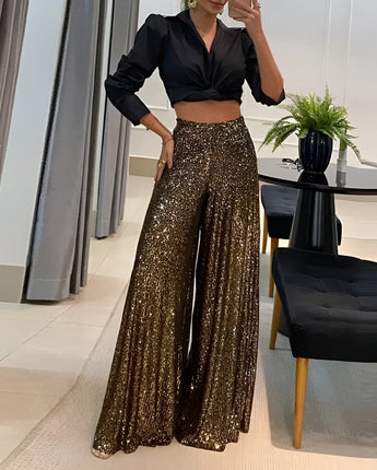 Goldene Pailletten-Hosen mit weitem Bein, die elegant und glänzend wirken, ideal für Abendmode-Anlässe, getragen von einer Person.