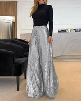 
A pair of wide-legged gold sequin pants designed for elegant evening wear, displayed on a mannequin in a fashion setting.