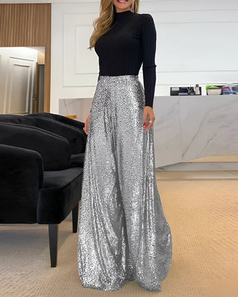 
A pair of wide-legged gold sequin pants designed for elegant evening wear, displayed on a mannequin in a fashion setting.