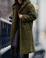 
A long, blue teddy coat for women, featuring a plush and fluffy texture, styled in a winter fashion. The coat is shown in a relaxed green variant, size XL, with features such as a wide collar, long sleeves, and a knee-length design.