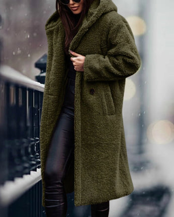 
A long, blue teddy coat for women, featuring a plush and fluffy texture, styled in a winter fashion. The coat is shown in a relaxed green variant, size XL, with features such as a wide collar, long sleeves, and a knee-length design.