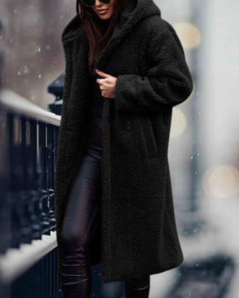 
A long black teddy coat for women in XL size, featuring a fluffy texture and designed for winter fashion. The coat resembles an overcoat or trench coat style, highlighting areas such as shoulders, neck, sleeves, waist, knees, and thighs.