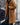 
A long blue teddy coat for women with a fluffy texture, featuring a tartan pattern and a fur-like appearance. The coat includes a collar, long sleeves, and extends to the knees, suitable for winter fashion. Modeled in the "Goldenes Kamel" color variant, size XL.