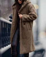 
A long, khaki teddy coat for women in size XL, featuring a plush texture ideal for winter fashion. The coat has a classic overcoat design with a collar, full-length sleeves, and a waist-length fit, providing warmth and style.