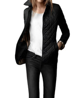 
A woman modeling a black double-breasted, tailored design jacket in a large 5XL size, featuring a quilted pattern. The jacket has a structured collar and long sleeves, accentuating the waist for a stylish and modern look.