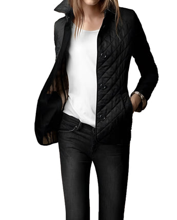 
A woman modeling a black double-breasted, tailored design jacket in a large 5XL size, featuring a quilted pattern. The jacket has a structured collar and long sleeves, accentuating the waist for a stylish and modern look.