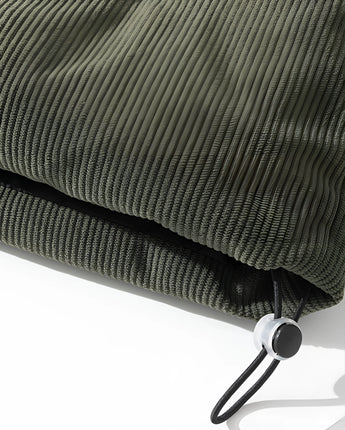 Green quilted urban-style puffer sofa with a modern design.