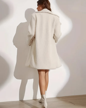 Oversized white teddy coat for women, featuring elegant design with a soft, plush texture; modeled with long sleeves and a wide collar.